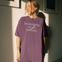 Woman wearing berry “Bookmarks Are for Quitters” tee with oversized fit – funny book lover t-shirt for avid readers