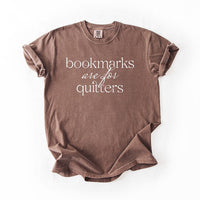 Flat lay of espresso “Bookmarks Are for Quitters” tee – witty book lover graphic t-shirt
