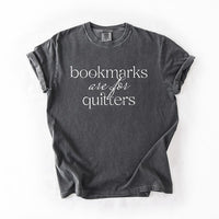 Flat lay of pepper “Bookmarks Are for Quitters” tee – funny unisex reading t-shirt for book lovers