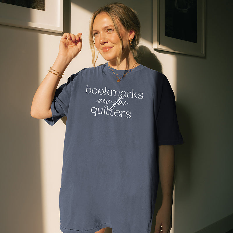 Woman wearing denim “Bookmarks Are for Quitters” tee with casual oversized fit – bookish outfit for readers and writers