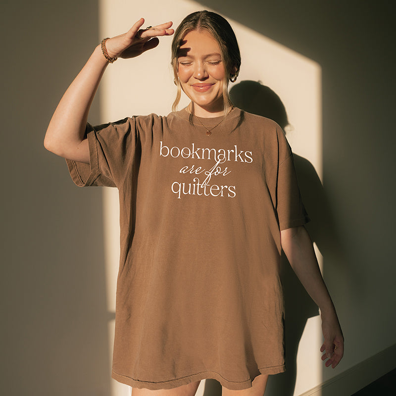Woman wearing espresso “Bookmarks Are for Quitters” tee indoors – soft oversized book lover t-shirt for women