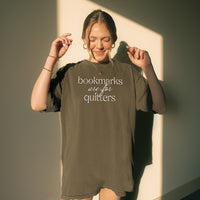 Woman wearing pepper “Bookmarks Are for Quitters” tee indoors – cozy oversized reading graphic tee for book lovers