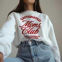 Woman wearing the Caffeinated Moms Club sweatshirt in white with red text — cozy mom life style.