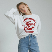 Relaxed lifestyle photo of woman in Caffeinated Moms Club sweatshirt — cozy coffee lover outfit perfect for moms on the go.