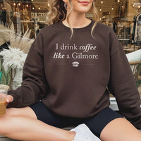 Female sitting outside bookstore with coffee, wearing dark chocolate Gilmore Girls sweatshirt and biker shorts – casual coffee lover style
