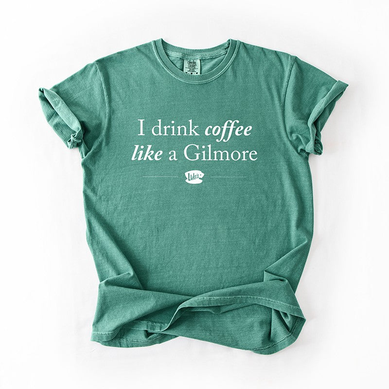 I Drink Coffee Like A Gilmore tee flat lay in light green, heavyweight unisex Gilmore Girls inspired graphic t-shirt