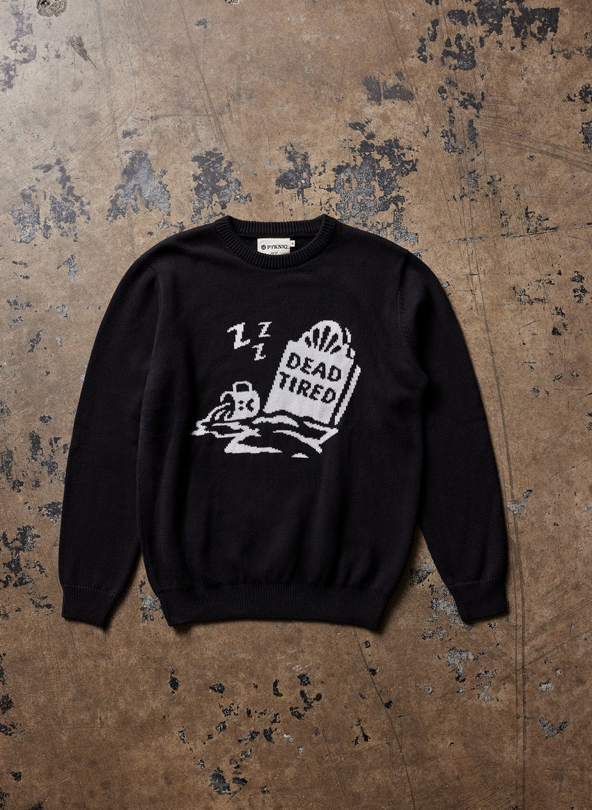 Black knit sweater with ribbed collar and cuffs, featuring a quirky knitted “Dead Tired” design with coffee-themed artwork; cozy unisex style for caffeine lovers.