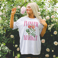 Model wearing ash Flower Market tee — relaxed fit floral graphic shirt for warm weather