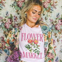 Model in soft pink lightweight tee — women’s floral spring shirt with vintage vibes