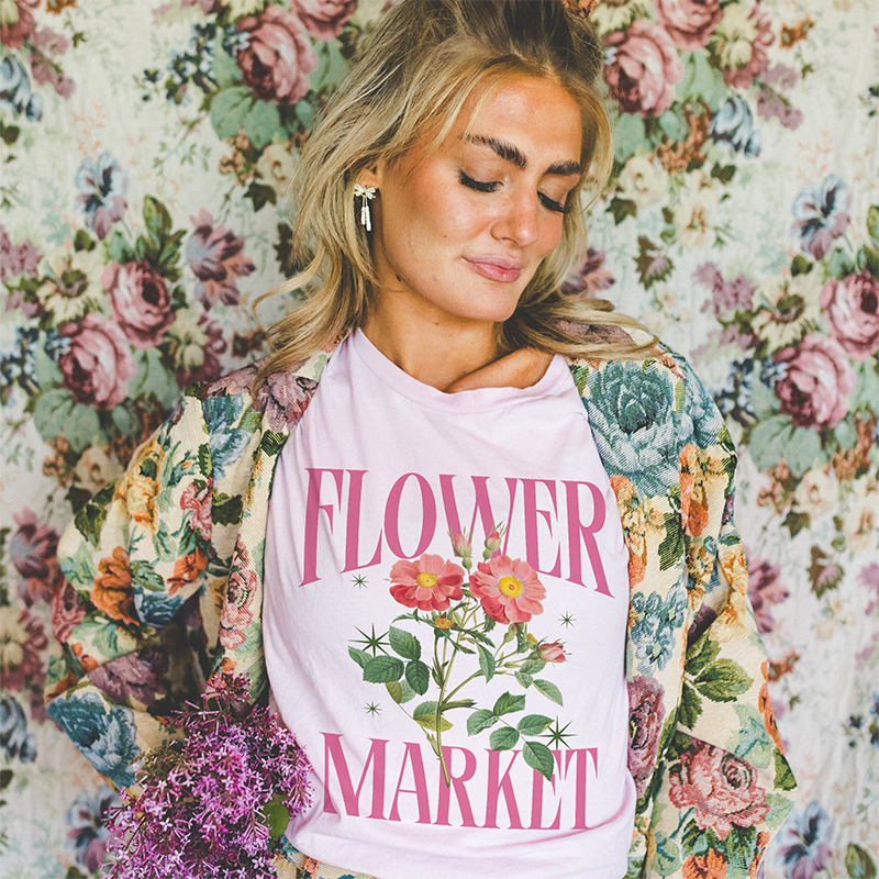 Model in soft pink lightweight tee — women’s floral spring shirt with vintage vibes