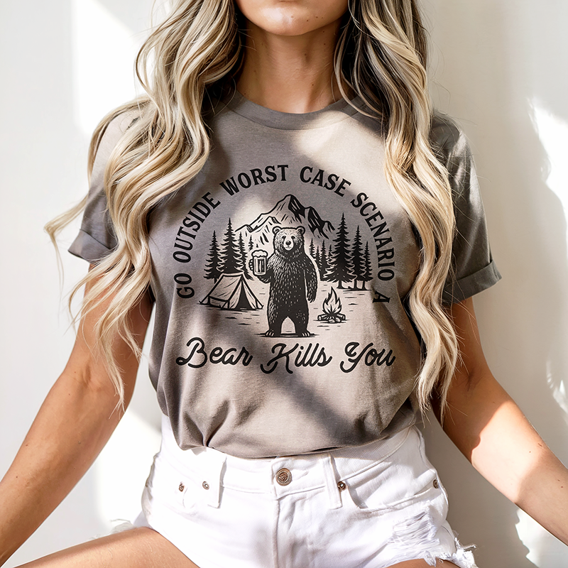 Model wearing Go Outside Bear Tee in pebble — funny adventure graphic t-shirt for men and women