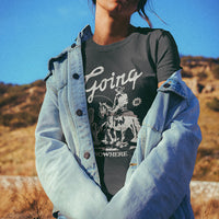 Model wearing Going Nowhere tee in desert with denim jacket — boho cowgirl outfit