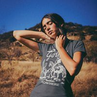 View of model soaking up the sun in Going Nowhere tee — relaxed fit country t-shirt for women