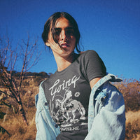 Close-up of Going Nowhere graphic on lightweight tee — bold white western typography on navy