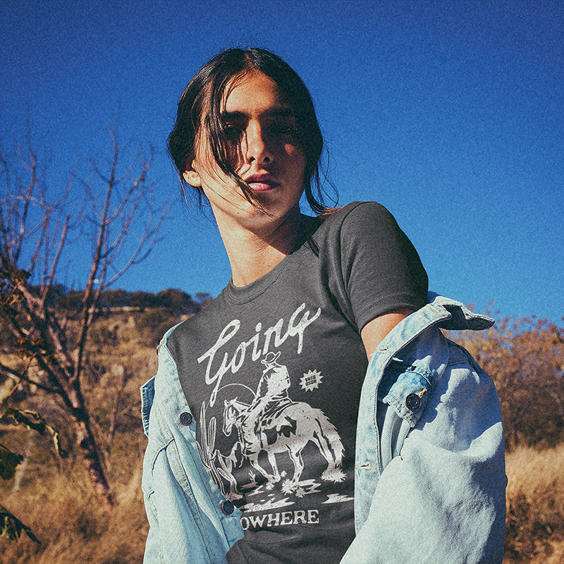 Close-up of Going Nowhere graphic on lightweight tee — bold white western typography on navy