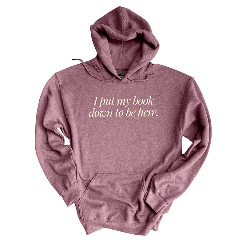 Flat lay of heather dark maroon “I Put My Book Down To Be Here” hoodie – cozy book lover hoodie for introverts and readers