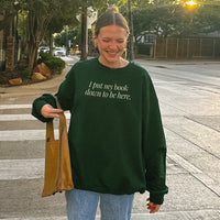 I Put My Book Down To Be Here Sweatshirt in forest green – outdoor photo of bookish graphic crewneck for readers.