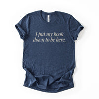 Flatlay of the I Put My Book Down To Be Here Tee in heather navy – lightweight Bella Canvas book lover shirt.