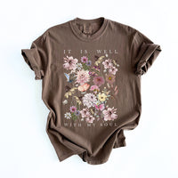 Flat lay of It Is Well With My Soul tee — hand-printed multicolor graphic on brown shirt