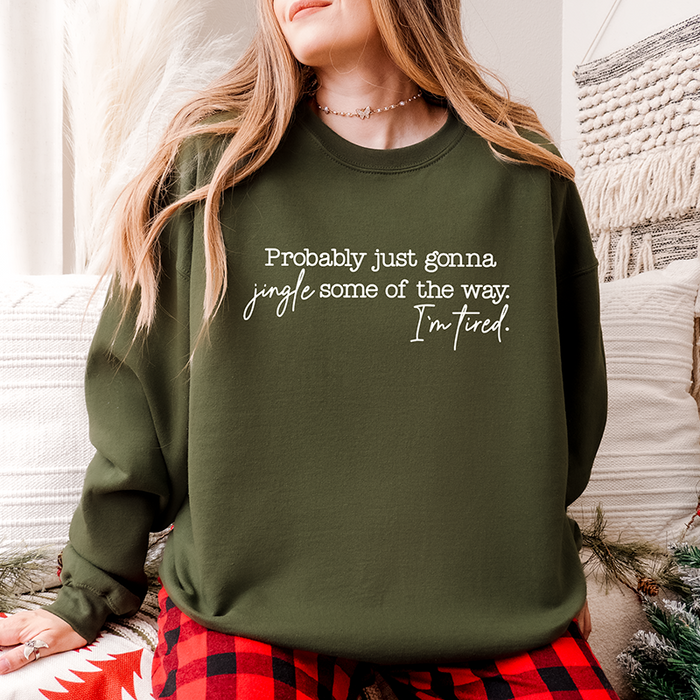 Woman wearing military green “Probably Just Gonna Jingle Some of the Way” crewneck – funny Christmas sweatshirt for tired holiday people