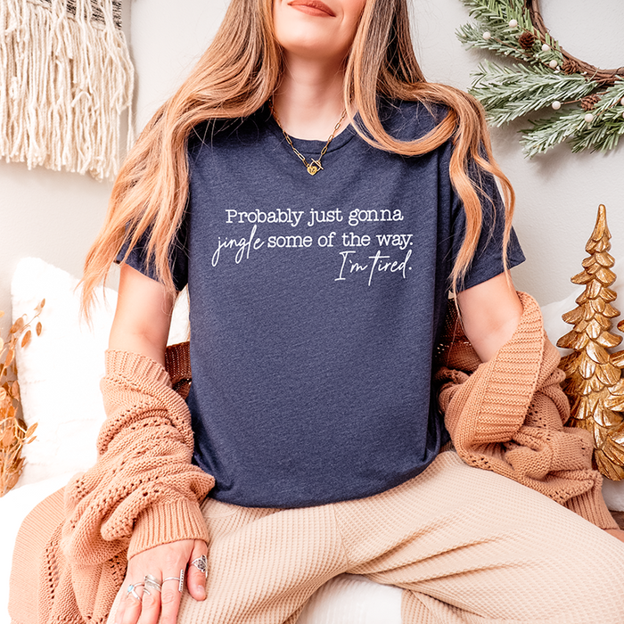 Woman wearing heather navy Christmas tee styled with winter décor – humorous festive unisex t-shirt