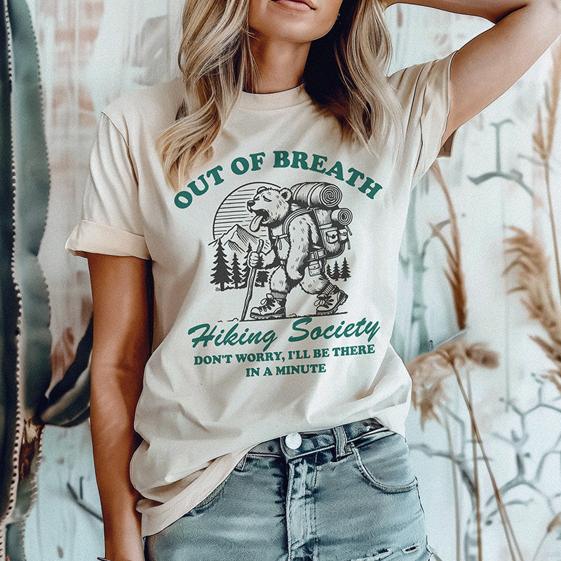 Model wearing Out of Breath Hiking Society tee in heather dust — funny lightweight trail shirt for women