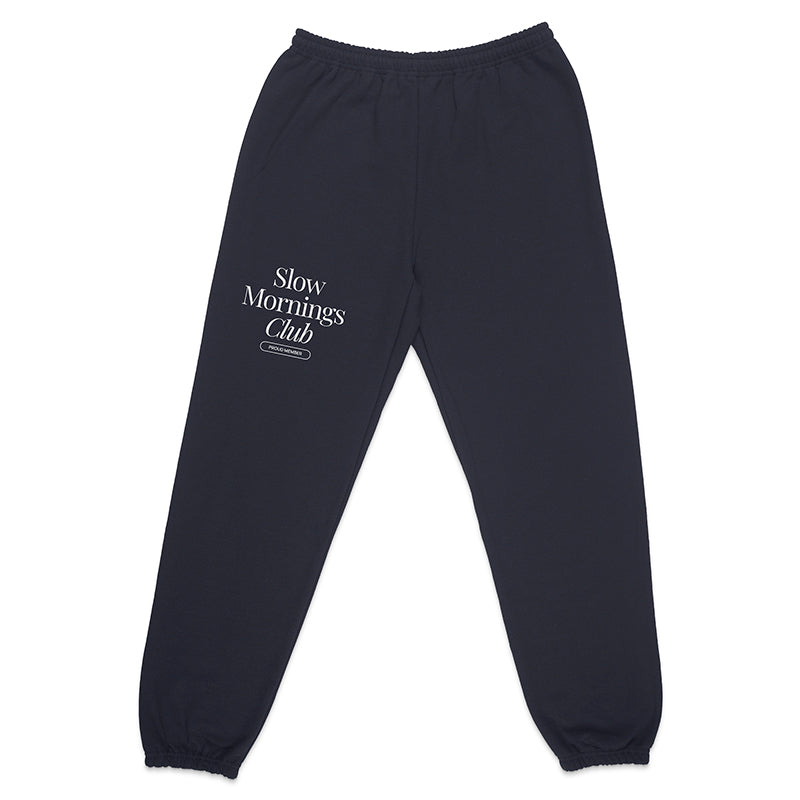 Flatlay of navy Slow Mornings Club jogger sweatpants with minimalist graphic and adjustable drawcord
