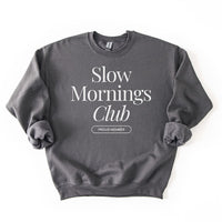 Flatlay of charcoal gray Slow Mornings Club sweatshirt featuring Slow Mornings Club design