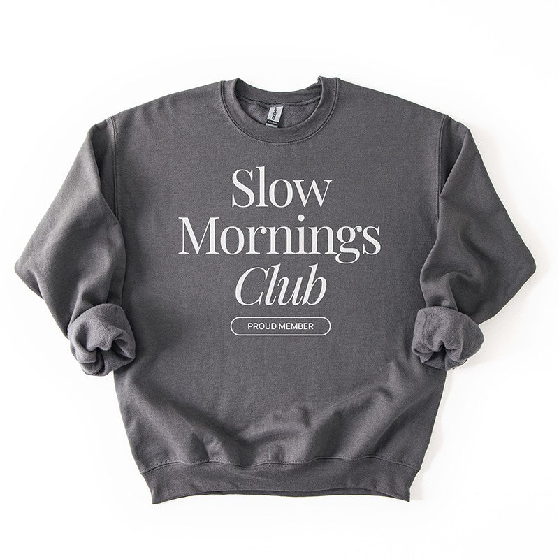 Flatlay of charcoal gray Slow Mornings Club sweatshirt featuring Slow Mornings Club design