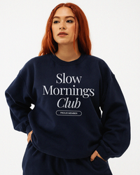 Model wearing navy Slow Mornings Club sweatshirt, casual everyday outfit