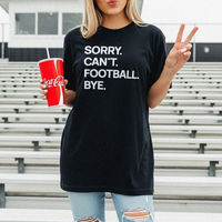Woman standing in stadium bleachers wearing the black “Sorry. Can’t. Football. Bye.” tee with jeans — soft unisex triblend game-day t-shirt for football fans.