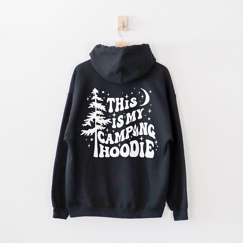 Flat lay of black hoodie showing back graphic — unisex camping hoodie for men and women