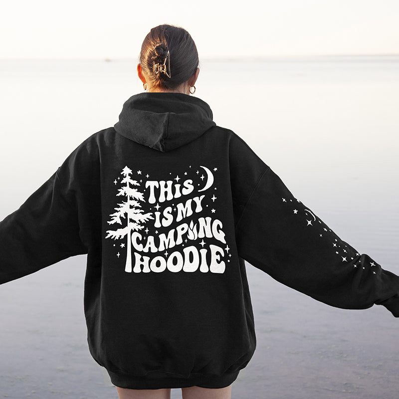 Model wearing This Is My Camping Hoodie in black — funny outdoor sweatshirt with back print