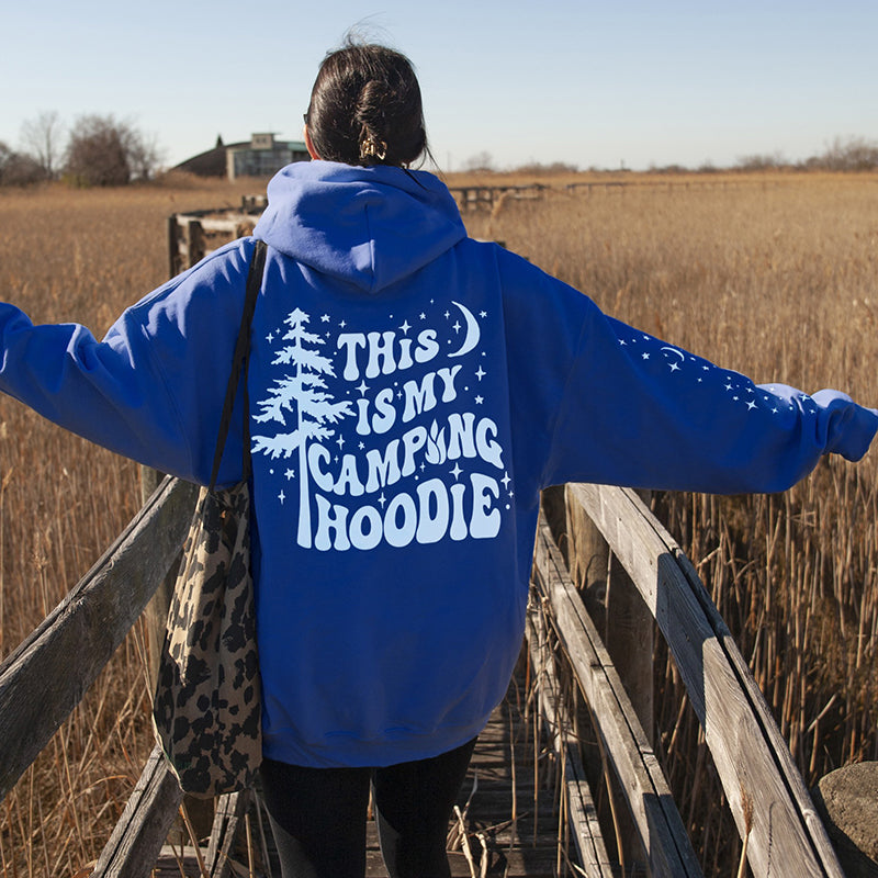 Model wearing royal blue camping hoodie — relaxed fit graphic hoodie with sleeve and back print