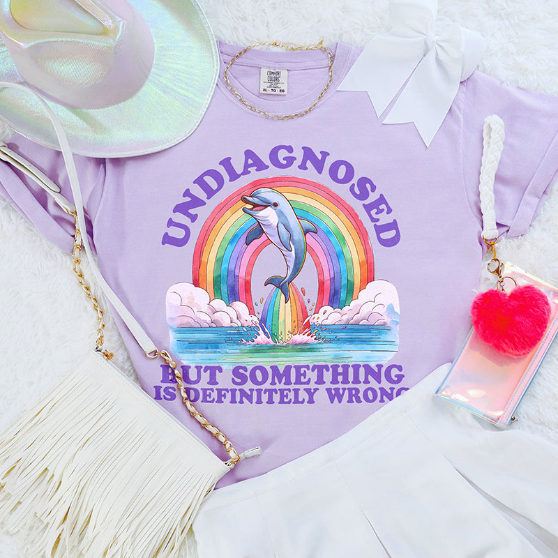 Flat lay of orchid funny heavyweight graphic tee — Undiagnosed But Something Is Wrong design