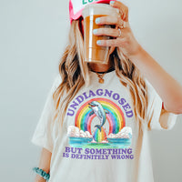 Model wearing Undiagnosed But Something Is Wrong lightweight tee in natural — soft funny triblend graphic shirt