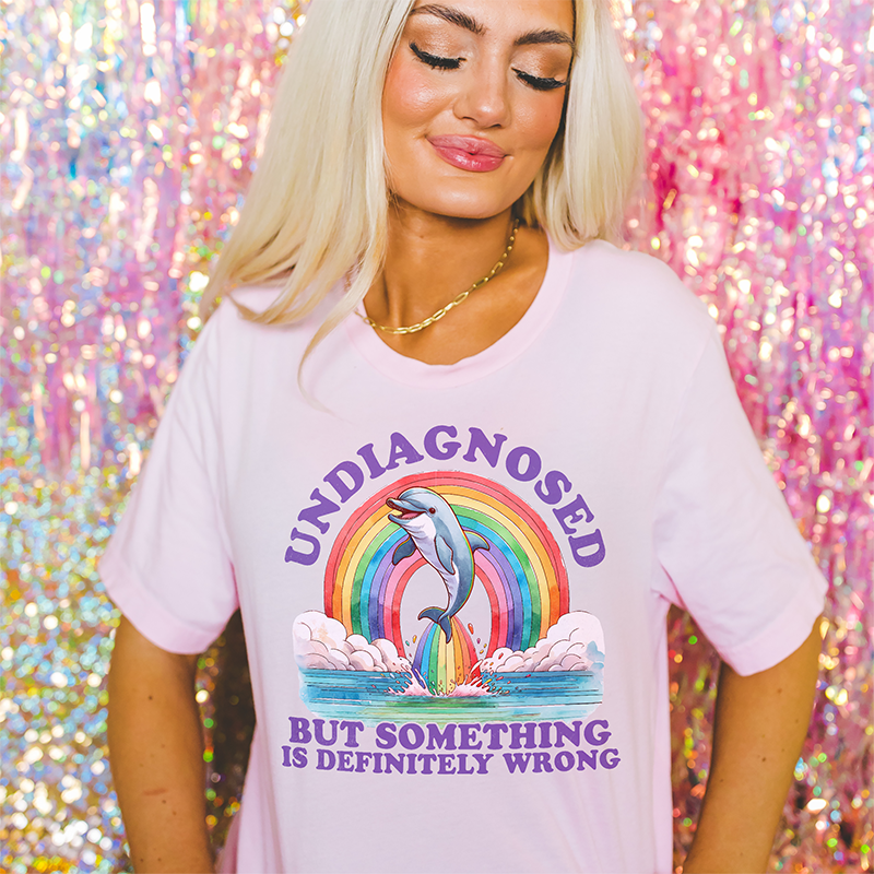 Model wearing pink lightweight Undiagnosed tee — pastel funny women’s triblend graphic shirt