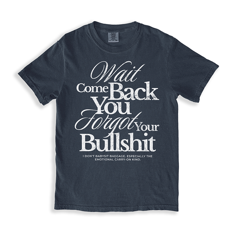 Flat lay of the Wait Come Back You Forgot Your Bullshit graphic tee in midnight – soft heavyweight cotton with bold white text.